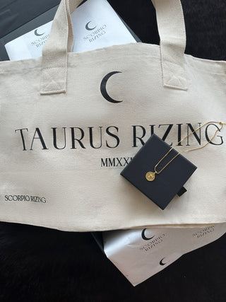 'Occasion Gifting SetLooking for the perfect gift for that Taurus in your life? Our stunning 18K gold plated Taurus necklace comes with our best selling Taurus Cotton Tote Bag and both aTaurus L'Occasion Gifting Set